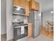 Modern kitchen featuring stainless steel appliances and wooden cabinets at 2797 S Newton Way, Denver, CO 80236