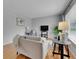 Cozy living room featuring neutral furniture, hardwood floors, and a large window at 2797 S Newton Way, Denver, CO 80236