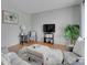 Bright living room with hardwood floors, soft gray walls, and comfortable seating arrangement at 2797 S Newton Way, Denver, CO 80236