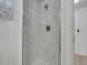 Updated shower features marble style tile, modern fixtures, and new fixtures at 2797 S Newton Way, Denver, CO 80236