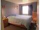 Comfortable bedroom with a queen-sized bed, natural light, and gray walls at 8781 N Pierce Way # 102, Arvada, CO 80003