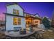 Backyard featuring a lit pergola covered patio, built-in grill, and a circular stone fire pit at 2342 Hickory Pl, Erie, CO 80516