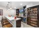 Basement bar area with pendant lights, quartz countertop, wet bar and TV at 2342 Hickory Pl, Erie, CO 80516