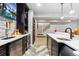 Wet bar in basement featuring a stone backsplash, quartz counters and stainless steel appliances at 2342 Hickory Pl, Erie, CO 80516