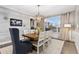 Comfortable dining room area featuring modern lighting fixtures, a large window, and stylish decor at 2342 Hickory Pl, Erie, CO 80516