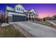 Attractive two-story house with a paved driveway leading to a two-car garage and a covered front porch at 2342 Hickory Pl, Erie, CO 80516