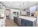 Open-concept kitchen with a large center island, stainless steel appliances, and views into the living room at 2342 Hickory Pl, Erie, CO 80516