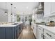 Stylish kitchen featuring stainless steel appliances, white cabinetry, backsplash, and spacious countertops at 2342 Hickory Pl, Erie, CO 80516