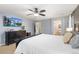 Bright main bedroom with mounted TV and ensuite bathroom access featuring great natural light and soft neutral tones at 2342 Hickory Pl, Erie, CO 80516