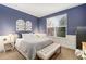 Serene main bedroom with blue walls, plush bedding, and a large window for natural light at 2342 Hickory Pl, Erie, CO 80516