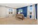 Bright home office with a blue accent wall, two windows with modern shades, and a stylish wooden desk at 2342 Hickory Pl, Erie, CO 80516