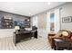 Cozy home office featuring natural light, plush seating, and shelving for functional decor at 2342 Hickory Pl, Erie, CO 80516