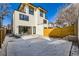 Modern home's backyard with patio, sleek design, and partial snow cover at 374 S Humboldt St, Denver, CO 80209