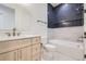 Chic bathroom featuring blue subway tile, a modern vanity, and a luxurious bathtub for a spa-like experience at 374 S Humboldt St, Denver, CO 80209