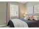 Bedroom featuring a navy blue comforter and soft pink accents, providing a cozy ambiance at 3887 Grand Baker St, Aurora, CO 80019