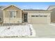 Charming single-story home featuring a two-car garage and a welcoming front entrance with stone accents at 3887 Grand Baker St, Aurora, CO 80019