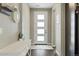 Bright foyer features a modern entry door, neutral paint, and hard wood floors at 3887 Grand Baker St, Aurora, CO 80019