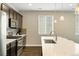 Well-equipped kitchen with dark cabinetry, stainless steel appliances, and a stylish backsplash at 3887 Grand Baker St, Aurora, CO 80019