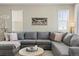 Inviting living room features a large sectional sofa, soft lighting, and comfortable decor at 3887 Grand Baker St, Aurora, CO 80019