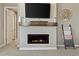 Stylish fireplace with mantle, decorative shelving, and cozy fireplace at 3887 Grand Baker St, Aurora, CO 80019