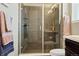 Walk-in shower features sleek glass doors and modern fixtures, offering a spa-like experience at 3887 Grand Baker St, Aurora, CO 80019