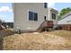 View of the home's backyard featuring a small patio and grassy area at 19524 Montview Dr, Aurora, CO 80011