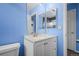 Bathroom with white vanity, twin mirrors, and commode at 19524 Montview Dr, Aurora, CO 80011