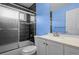 Bathroom with tiled walls, shower over tub, white vanity and commode at 19524 Montview Dr, Aurora, CO 80011