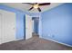Bedroom featuring blue walls, carpet, a ceiling fan, and a large closet at 19524 Montview Dr, Aurora, CO 80011