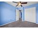Bedroom featuring blue walls, carpet, a ceiling fan, and a large closet for storage at 19524 Montview Dr, Aurora, CO 80011
