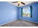 Bedroom featuring blue walls, a ceiling fan, and a window with natural light at 19524 Montview Dr, Aurora, CO 80011