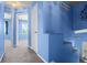 Hallway with carpet, blue walls, and white doors leading to bedrooms and the upper-level stairs at 19524 Montview Dr, Aurora, CO 80011