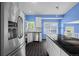 Open kitchen featuring stainless steel appliances, white cabinets, and sleek dark flooring at 19524 Montview Dr, Aurora, CO 80011