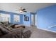 Comfortable living area with a large sectional sofa, ceiling fan, and ample natural light at 19524 Montview Dr, Aurora, CO 80011