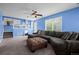 Cozy living room featuring a large sectional sofa and ample natural light from a window at 19524 Montview Dr, Aurora, CO 80011