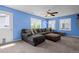 Spacious living area with plush sectional sofa, soft carpet, and natural lighting at 19524 Montview Dr, Aurora, CO 80011