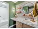 Bathroom featuring a round mirror and a vanity with marble countertops at 2835 S Monaco Pkwy # 1-103, Denver, CO 80222
