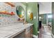 Bathroom featuring a stylish vanity with a round mirror and wood shelving at 2835 S Monaco Pkwy # 1-103, Denver, CO 80222