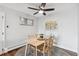 Bright dining area features a ceiling fan, contemporary art, a window, and modern decor for comfortable living at 2835 S Monaco Pkwy # 1-103, Denver, CO 80222