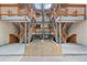 Apartment building exterior featuring multiple levels with open staircases and landscaped rock garden at 2835 S Monaco Pkwy # 1-103, Denver, CO 80222