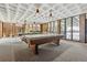 Spacious game room featuring pool tables, ample lighting, and views of the outdoor pool area at 2835 S Monaco Pkwy # 1-103, Denver, CO 80222