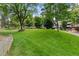 Lush green space with mature trees, manicured lawns, and walking paths in a serene community setting at 2835 S Monaco Pkwy # 1-103, Denver, CO 80222