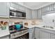Updated kitchen features stainless steel appliances and plenty of cabinet space at 2835 S Monaco Pkwy # 1-103, Denver, CO 80222