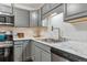 Modern kitchen features stainless steel appliances, updated lighting and marble-look countertops at 2835 S Monaco Pkwy # 1-103, Denver, CO 80222