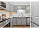 Stylish kitchen with updated appliances, countertop, and a convenient open layout to pantry at 2835 S Monaco Pkwy # 1-103, Denver, CO 80222