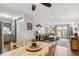 Open concept living space with dining area, kitchen, and comfortable living room setup with patio access at 2835 S Monaco Pkwy # 1-103, Denver, CO 80222