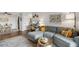 Well-lit living room with a sectional sofa, desk area, dining table, and contemporary artwork at 2835 S Monaco Pkwy # 1-103, Denver, CO 80222
