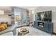 Bright living room with a sliding glass door to a private patio, and a modern entertainment center at 2835 S Monaco Pkwy # 1-103, Denver, CO 80222