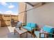 Cozy outdoor patio featuring comfortable blue cushioned seating and stylish decor, perfect for relaxation at 2835 S Monaco Pkwy # 1-103, Denver, CO 80222