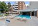 Inviting pool area with comfortable seating and views of the building's modern architecture at 2835 S Monaco Pkwy # 1-103, Denver, CO 80222